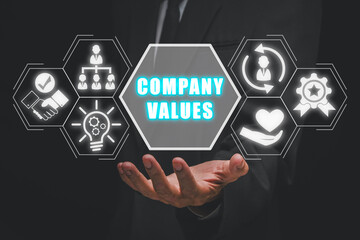 Company values concept, Businessman hand holding company values icon on virtual screen.