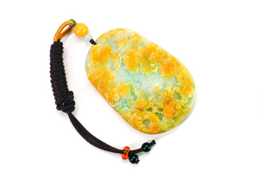 Jade pendant isolated on white background. Tri color Jadeite jade pendant with mountain, waterfall, pine tree, towers and bridge carvings. Natural tri color Burmese jadeite jade pendant