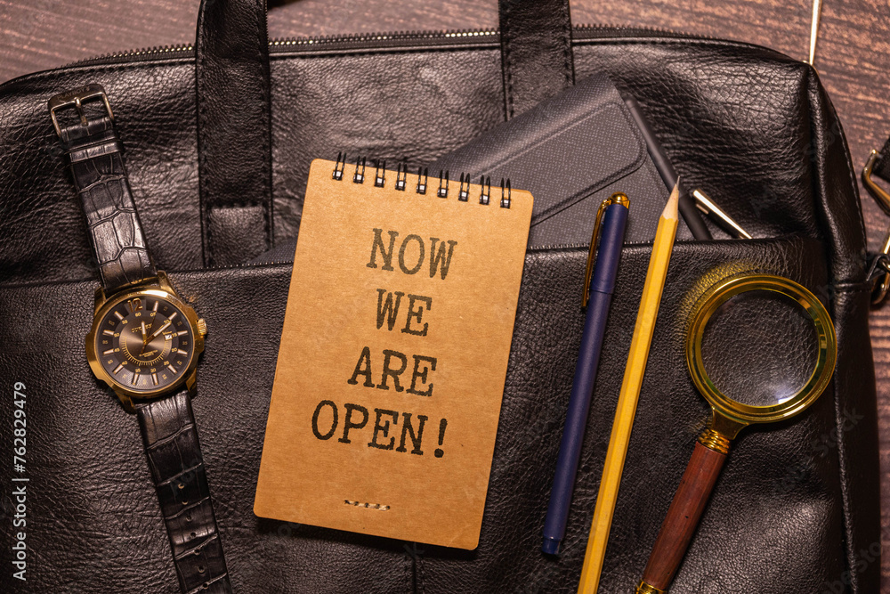 Poster notepad with text now opening on a charts and numbers. business concept.