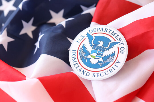 KYIV, UKRAINE - MARCH 9, 2024 US Department of Homeland Security seal on United States of America flag close up