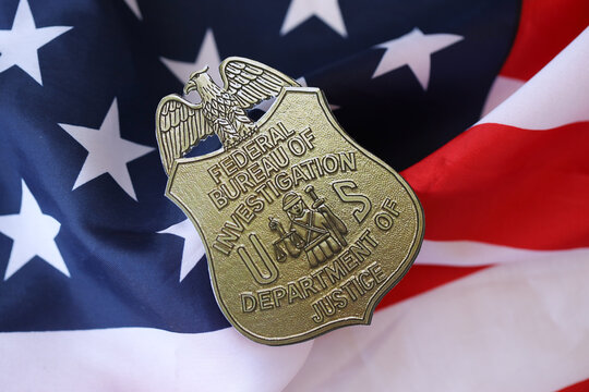 KYIV, UKRAINE - MARCH 9, 2024 US FBI Federal Bureau of Investigation badge on United States of America flag close up