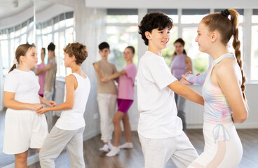 Pair of teen girl and guy enjoying of waltz dance in choreo class. Exciting hobby, active...