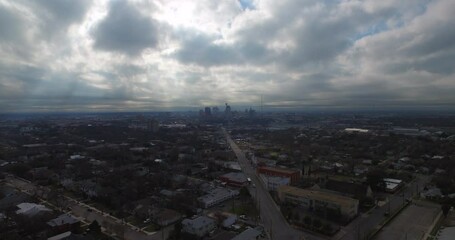 An Expansive Aerial Shot Captures A City'S Silhouette Against A Dramatic Cloudy Sky, With Roads Weaving Through The Urban Grid Towards The Distant Skyline - San Antonio, Texas
