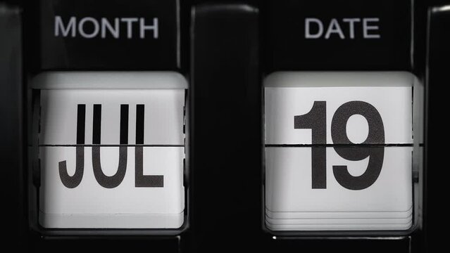 retro flip calendar with a date change from the eighteenth of July to the nineteenth of July. daily calendar with a change of days of the month. close up.