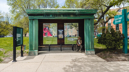 man sitting in bus stop