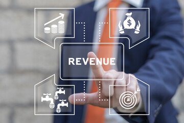 Business man using virtual touch screen presses word: REVENUE. Concept of multiplying sources of...