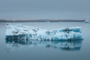 Iceberg floating in the Jokulsarlon glacier lagoon lake at the edge of Vatnajokull National Park in...