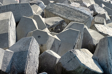 A collection of intricate concrete shapes designed to serve as robust coastal defences against the sea