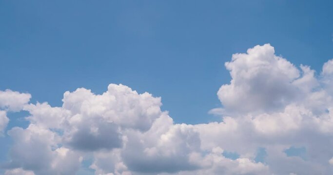 Timelapse Blue sky fluffy white clouds on summer season bright clear skyline with beautiful cloudscape. Timelapse Panorama blue sky clouds heaven on daylight with copy space. Cloudscape sunny day.