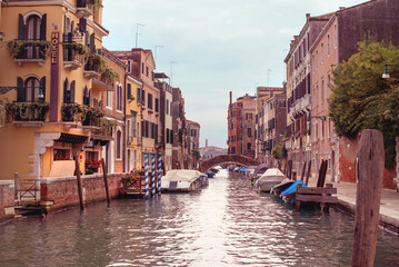 Venice canal with boats in autumn