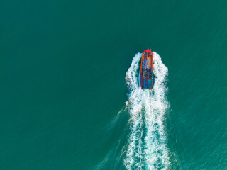 Vietnamese fishermen's fishing boat runs on the sea with an aerial view. Nautical and travel themed...