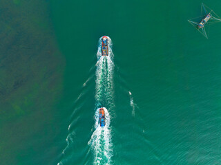 Aerial view of Vietnamese fishermen's fishing boat running on the sea. Tourism and maritime...