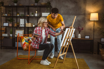 mother and son paint at home mentor artist help teach to create art
