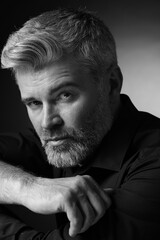 Portrait of handsome man on dark background. Black and white effect