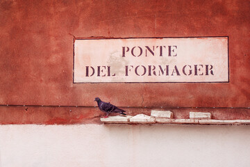 A sign with the name of a street in Venice, Italy - Powered by Adobe