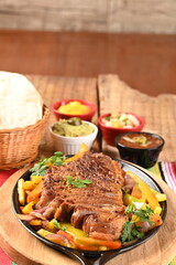 roast beef with seasonings and sliced ​​barbecue salad served on plate on wooden table