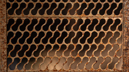 Rusty metal grid on a black background. Close-up.