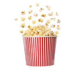Popcorn flying into bucket on white background