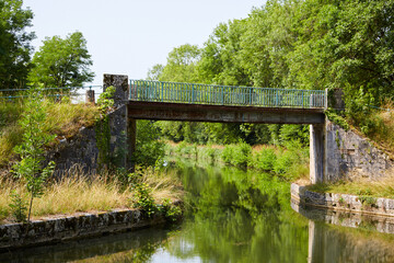 Fototapeta na wymiar Narrow Bridge Over a Calm River