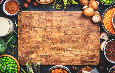 Vegan food background with copy space wooden cutting board. Plant protein., vegetarian nutrition sources. Healthy eating, diet ingredients: legumes, beans, lentils, nuts, soy milk, tofu, cereals, seed