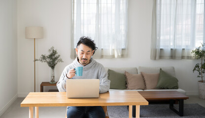 Image of a man teleworking or working at home or on a computer Serious and serious expression