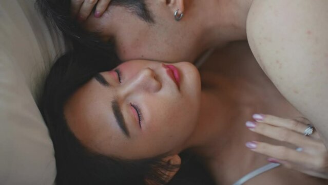 Asian sensual lover man and woman making love on bed in bedroom at home. 