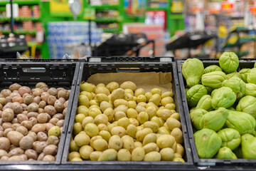 Stand of potatoes and chayote in a supermarket.