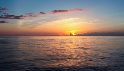 Beautiful sunset over the calm surface of the ocean