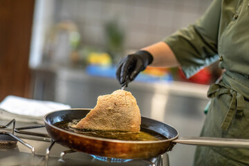 Authentic kitchen scene: Making a cordon bleu in a pan