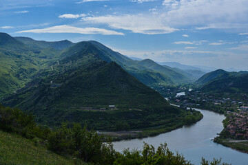 Mtskheta, Georgia. View of the mountains and the confluence of the Aragvi and Kura rivers from the heights of the Jvari monastery. - obrazy, fototapety, plakaty