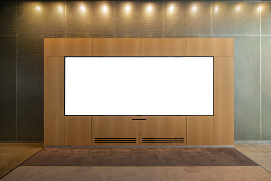 Texture background of a wooden wall unit with a large, horizontal blank display screen: a mockup template for a long, wide digital screen mounted on an urban indoor wall. Copy space for your design.