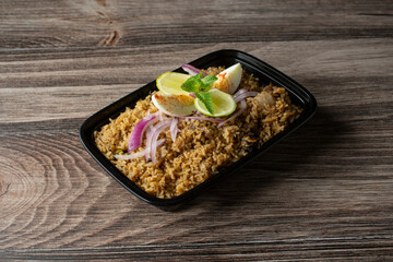 A view of a container of goat biryani.