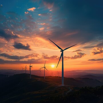 Wind turbines during breathtaking sunset - A stunning image showing wind turbines silhouetted against a vibrant sunset sky, symbolizing renewable energy