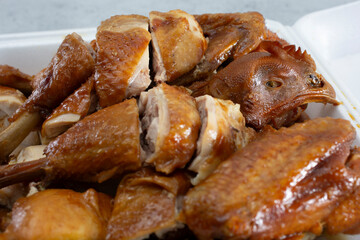 A closeup view of a whole soy sauce marinated chicken.