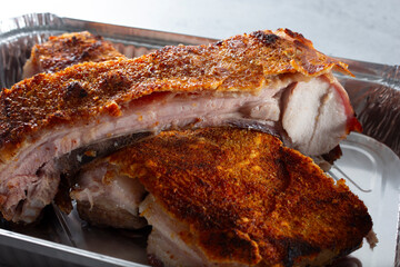 A view of slabs of pork belly in a tray.