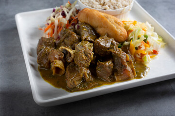 A view of a plate of curry goat.