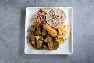 A top down view of a plate of curry goat.