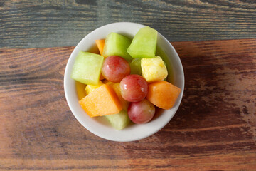 A top down view of a small bowl of fruit.