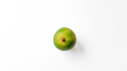 Fresh whole lime with a visible stalk end, centered on a clean white background with ample copy space, ideal for food and nutrition themes