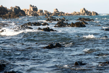 View of the surf at the rocky seaside