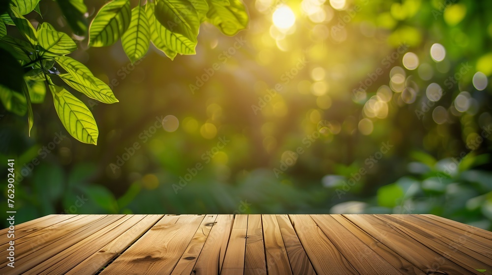 Poster wood table top on blur abstract green from garden in the morning backgroundfor montage product displ