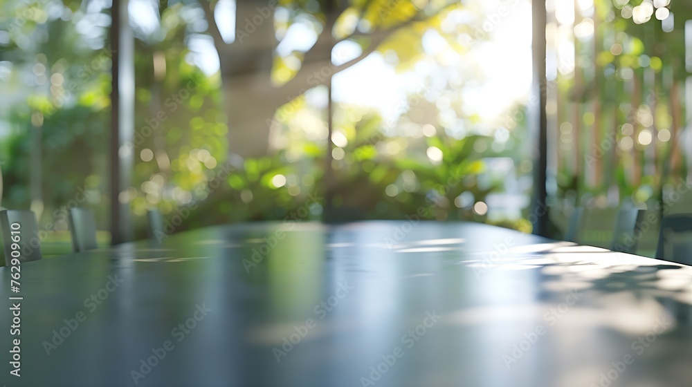 Poster blur meeting room table in office background with see through window to tree in garden in morning wi