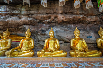 The gold Buddha statue in the cave at Wat Tham Khuha Sawan, Khong Chiam district, Ubon Ratchathani, Thailand