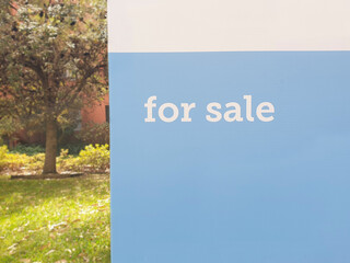 for sale sign outdoors in front yard of building