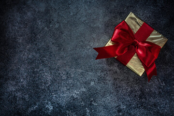Gold Wrapped Gift Box With Red Ribbon