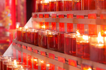 Candles for worship lit in a monastery in Jakarta's Chinatown area. translations: That is, the...