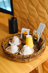 kettle, dishes and tea set on a wicker tray in the glamping room. 