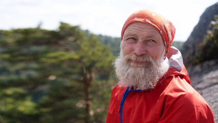 Portrait, close-up. a white elderly man and hiking in the woods, for a healthy lifestyle. The face...