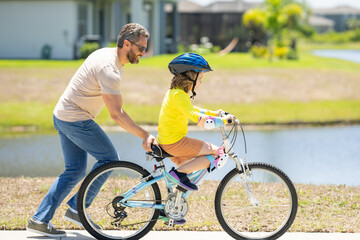 Happy Fathers day. Father and son in a helmet riding bike. Little cute adorable caucasian boy in...