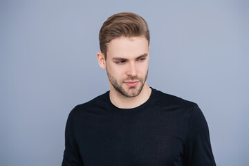 Fototapeta premium Guy has stylish haircut. Man with trendy hairstyle. Casual male style. Young Caucasian man isolated on grey. Confident man face portrait. Men skin care. Skincare of men. Handsomeness